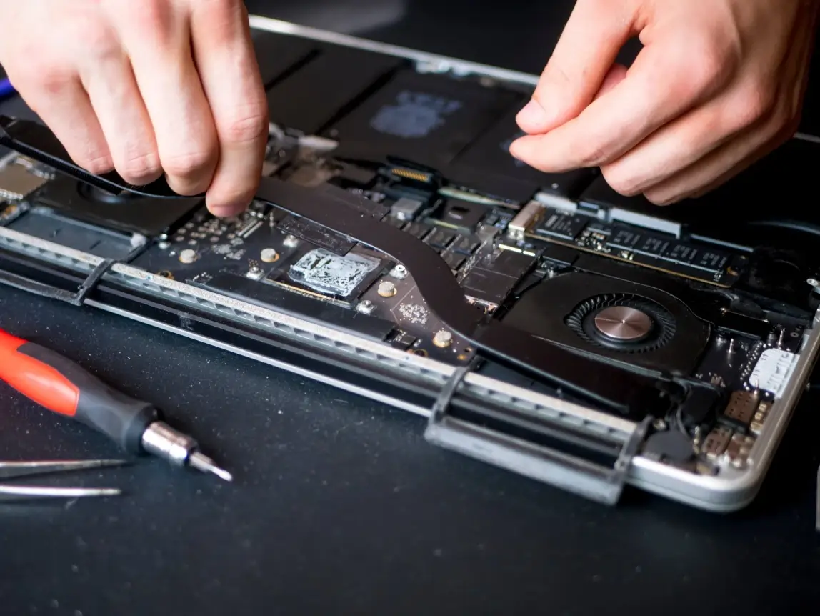 MacBook teardown — fan and heat pipe on the bench